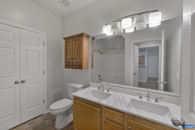 full bathroom featuring shower / bath combination, toilet, and vanity