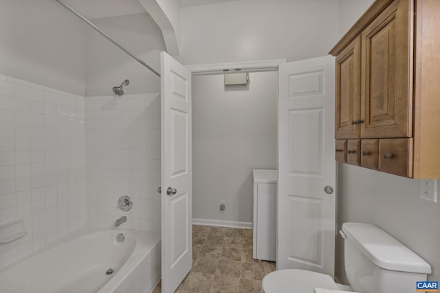 bathroom featuring shower / bath combination and toilet