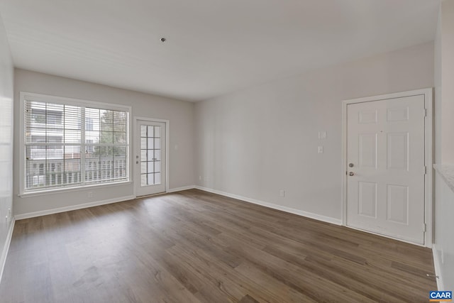 spare room with dark wood-type flooring