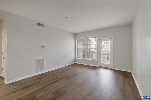 unfurnished room featuring dark wood-type flooring