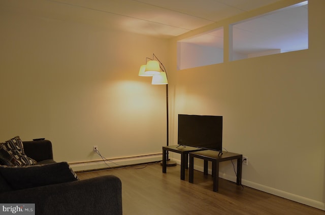 living room with baseboard heating and hardwood / wood-style flooring