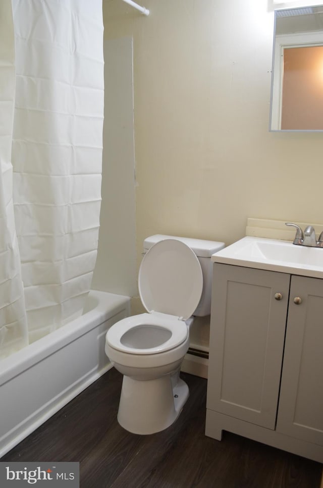 full bathroom featuring toilet, shower / bath combination with curtain, baseboard heating, vanity, and hardwood / wood-style flooring