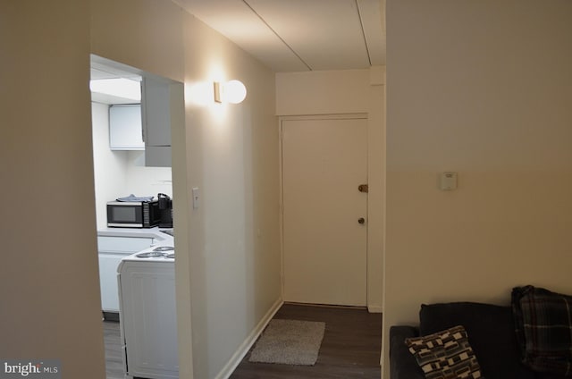 corridor featuring dark hardwood / wood-style flooring and washer / dryer