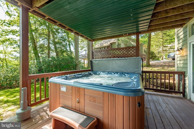 wooden terrace featuring a hot tub