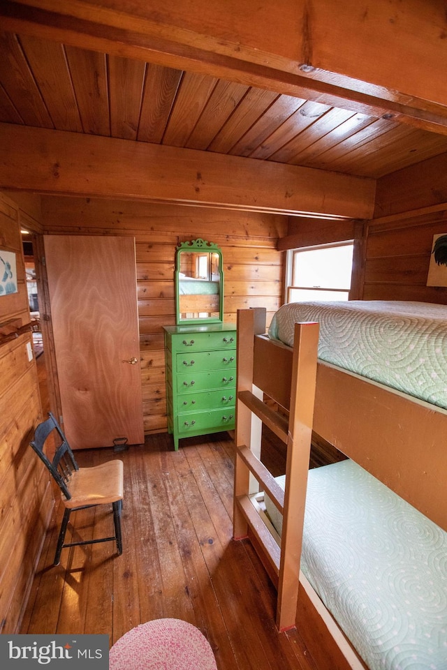 bedroom with hardwood / wood-style flooring, wooden ceiling, and wooden walls