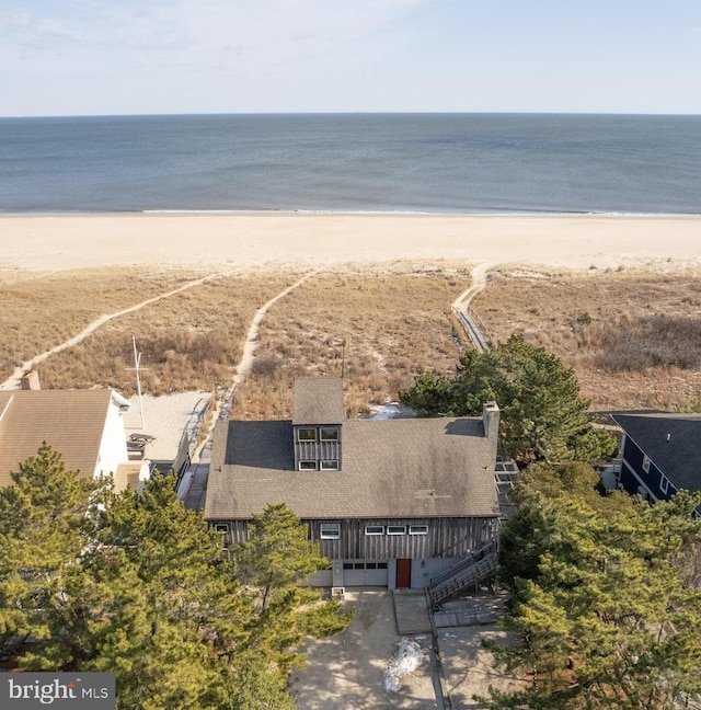 birds eye view of property featuring a water view and a view of the beach