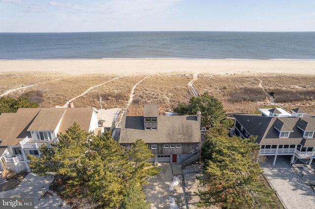 aerial view with a water view and a beach view