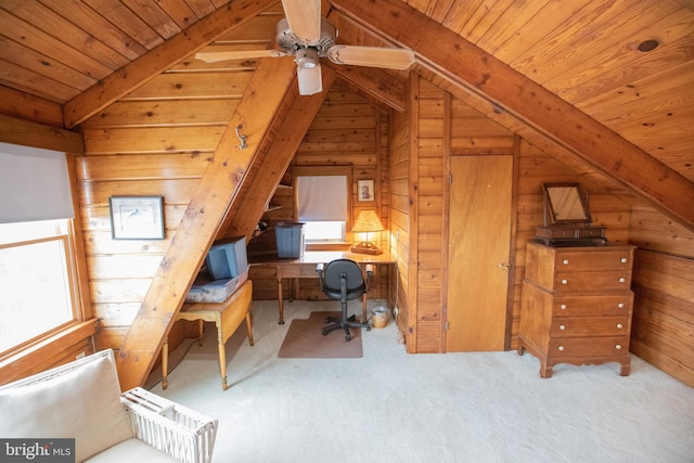 office area with wood ceiling, vaulted ceiling with beams, light carpet, and wood walls