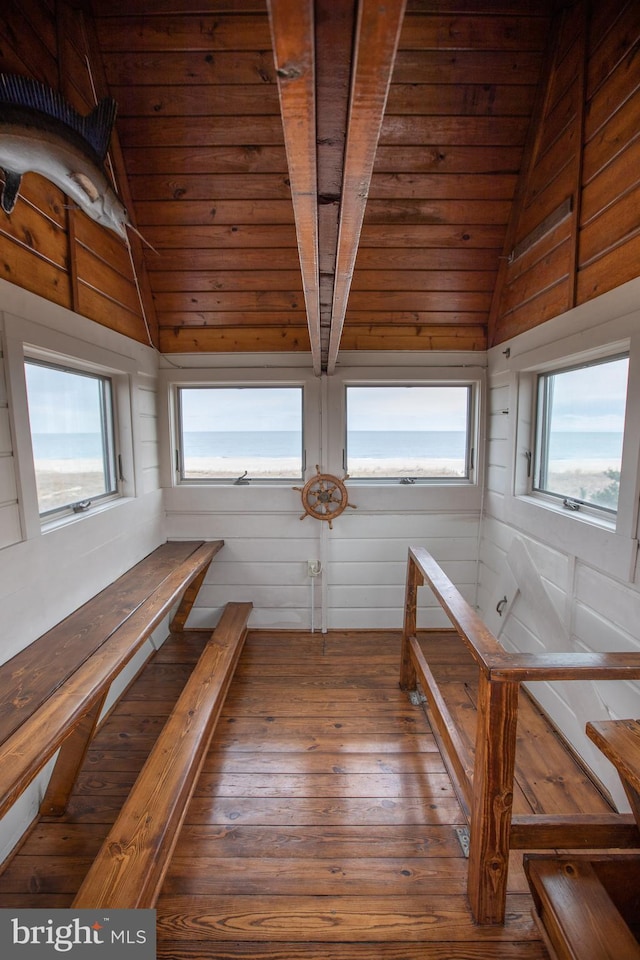 unfurnished sunroom featuring a wealth of natural light, vaulted ceiling, and wooden ceiling