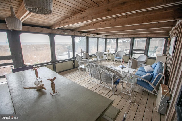 unfurnished sunroom with beamed ceiling, a healthy amount of sunlight, and wooden ceiling