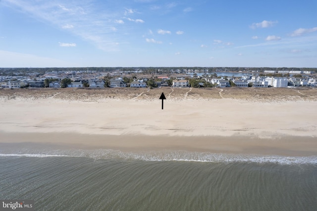 aerial view with a water view and a beach view