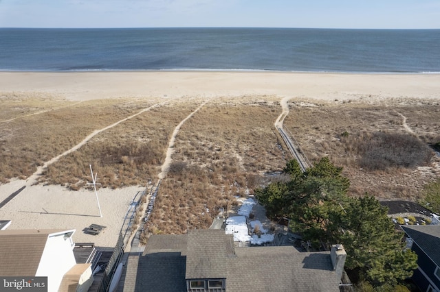 birds eye view of property with a water view and a view of the beach