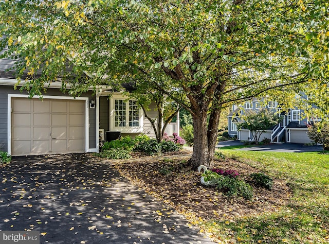 obstructed view of property with a garage