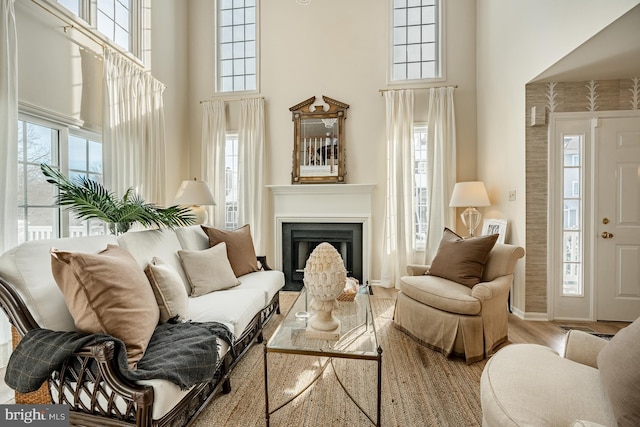 interior space with hardwood / wood-style floors and a towering ceiling