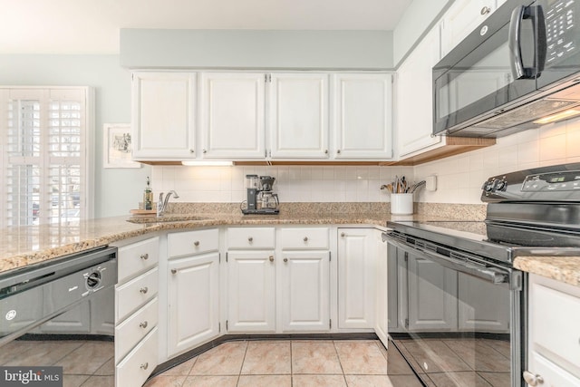 kitchen with black appliances, tasteful backsplash, a sink, and white cabinetry