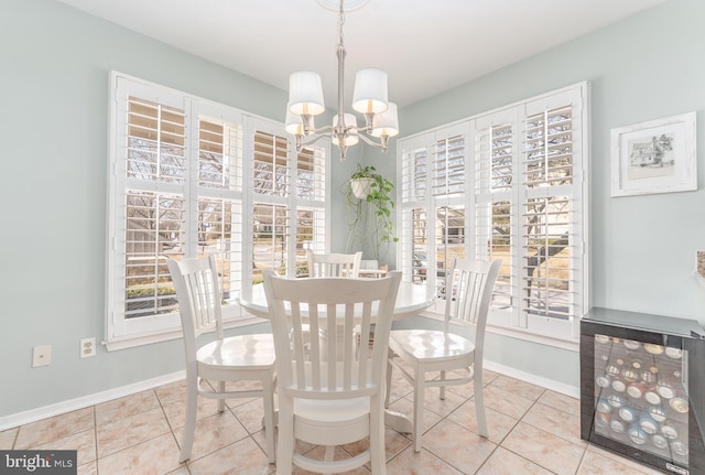 tiled dining room featuring baseboards, a chandelier, and beverage cooler