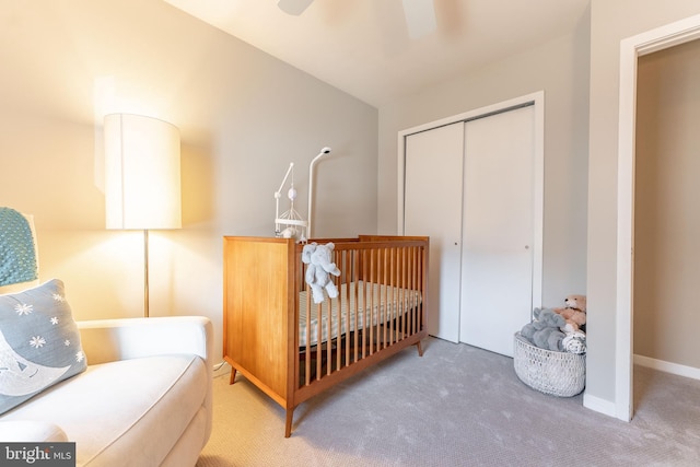 carpeted bedroom with a closet, a ceiling fan, and baseboards