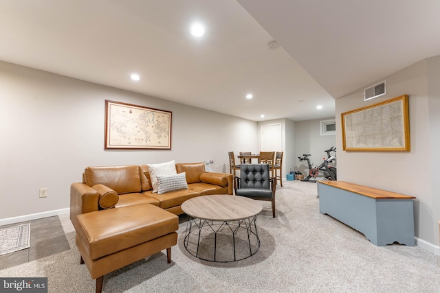 carpeted living area featuring baseboards, visible vents, and recessed lighting