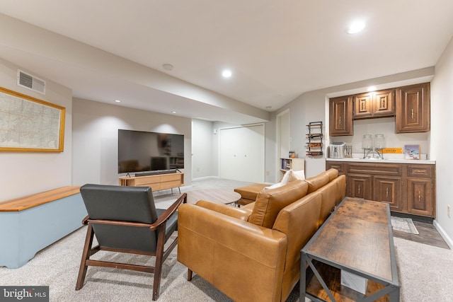 living room with recessed lighting, visible vents, and baseboards