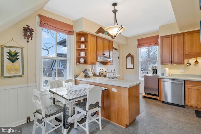 kitchen with under cabinet range hood, a wainscoted wall, a peninsula, stainless steel dishwasher, and open shelves