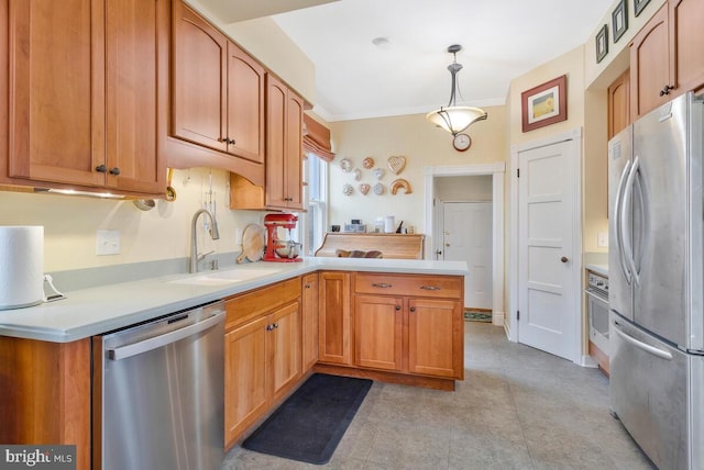 kitchen with light countertops, appliances with stainless steel finishes, ornamental molding, a sink, and a peninsula