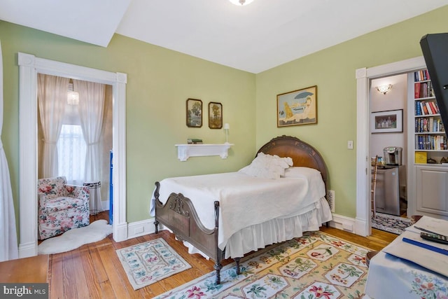 bedroom featuring light wood-style flooring and baseboards