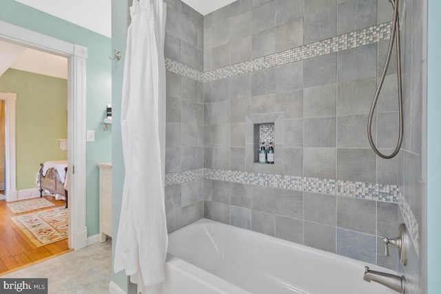 full bath with ensuite bathroom and shower / tub combo with curtain