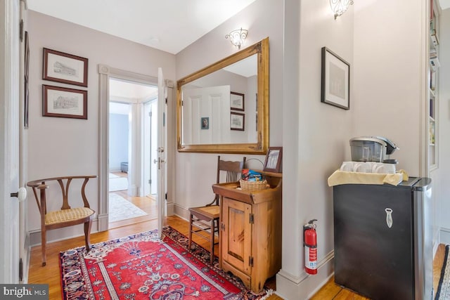 interior space with wood finished floors and baseboards