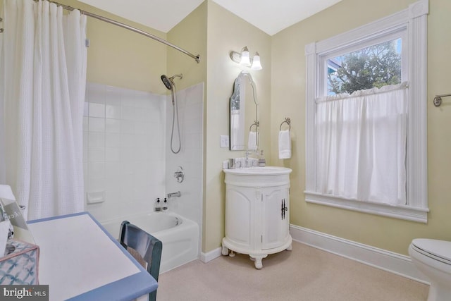 full bath featuring toilet, shower / bath combo, baseboards, and vanity