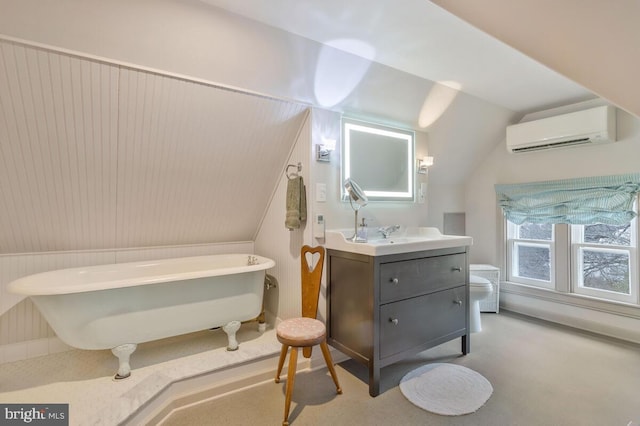 full bath with a soaking tub, toilet, an AC wall unit, vaulted ceiling, and vanity