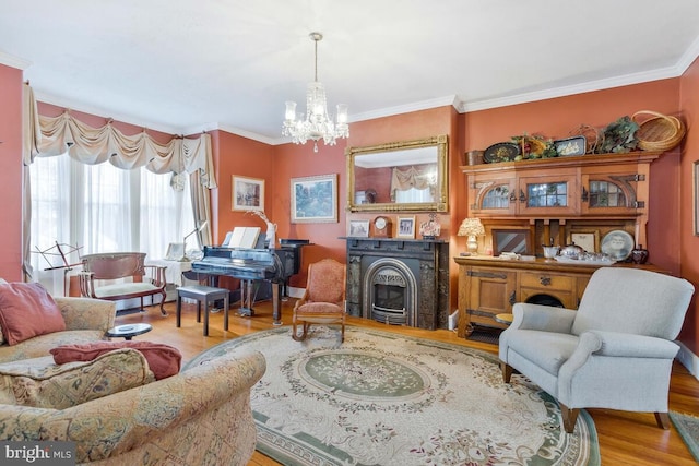 sitting room featuring ornamental molding, an inviting chandelier, and wood finished floors