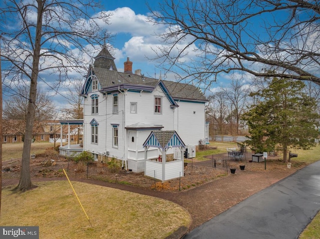 view of home's exterior with a yard and a chimney