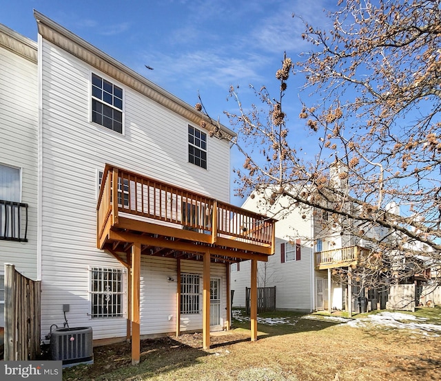 back of house featuring a wooden deck and cooling unit