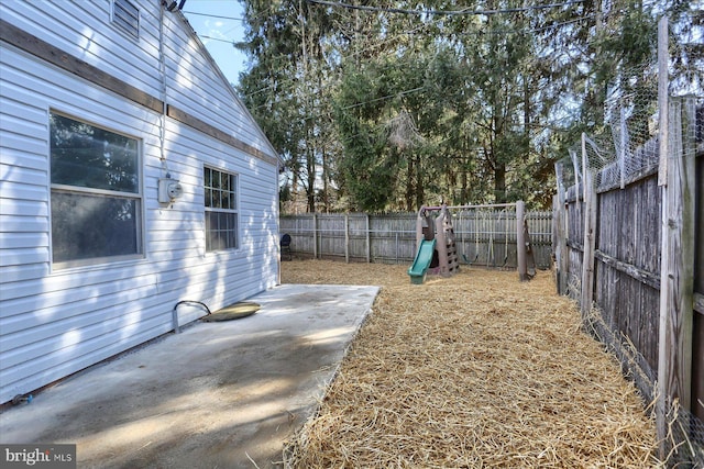 view of yard featuring a patio and a playground