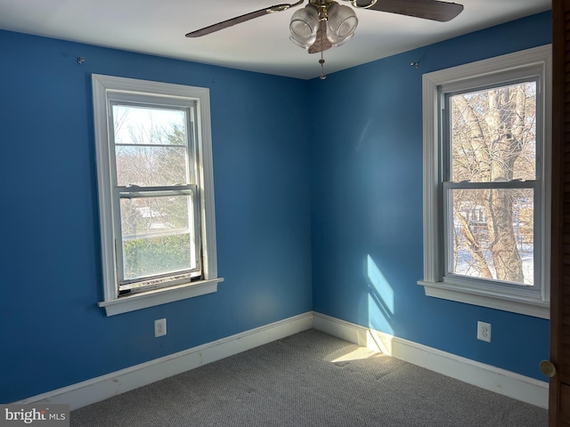 spare room featuring ceiling fan and carpet floors