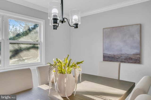 dining space featuring ornamental molding and a chandelier