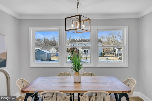 dining area featuring crown molding and an inviting chandelier