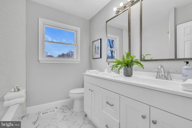 bathroom featuring toilet and vanity