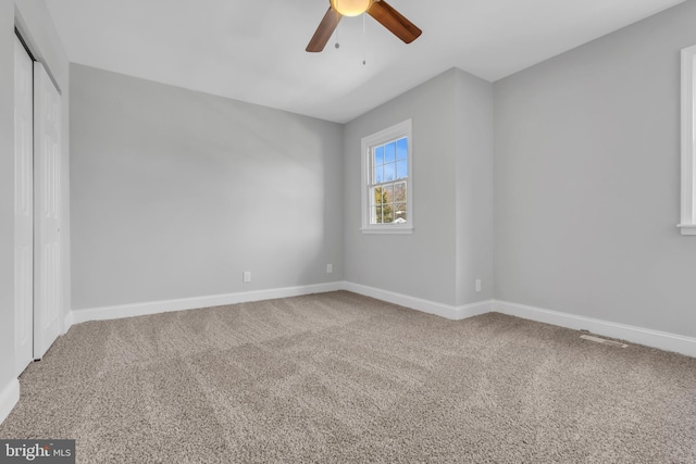 carpeted empty room with ceiling fan