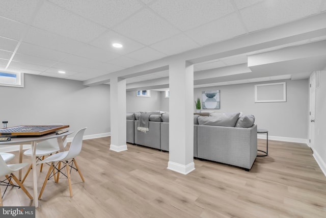 dining area with light hardwood / wood-style floors and a drop ceiling