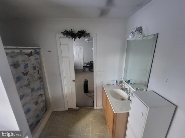 bathroom featuring vanity and curtained shower