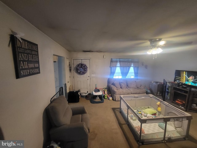 living room featuring ceiling fan and carpet flooring