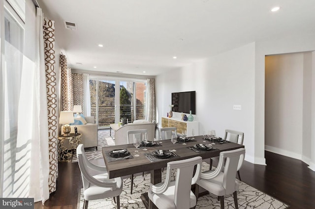 dining space with hardwood / wood-style flooring