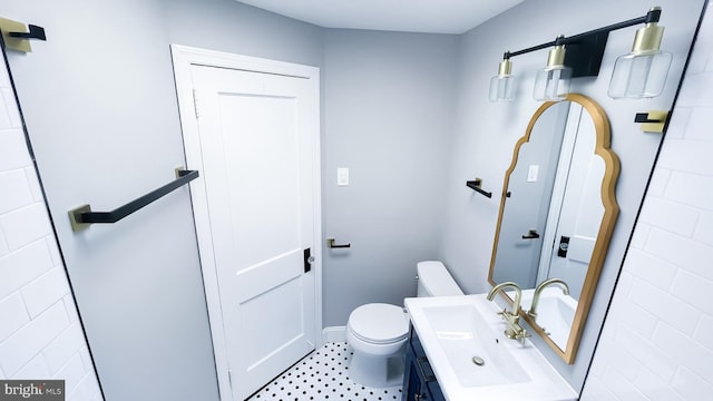 bathroom featuring toilet and vanity