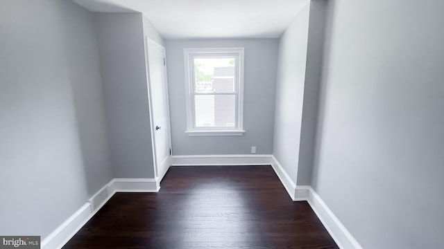 spare room with dark hardwood / wood-style flooring