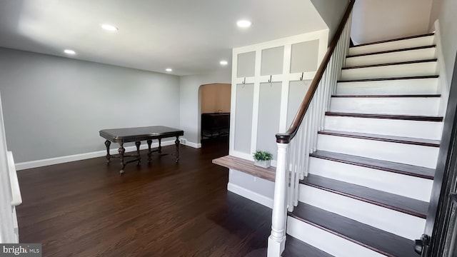 stairs featuring hardwood / wood-style floors