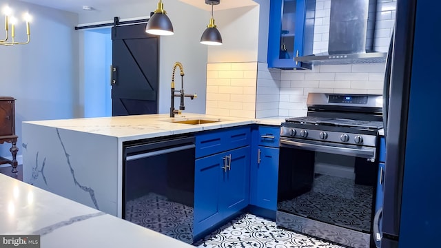 kitchen featuring a barn door, wall chimney range hood, fridge, stainless steel range with gas stovetop, and black dishwasher