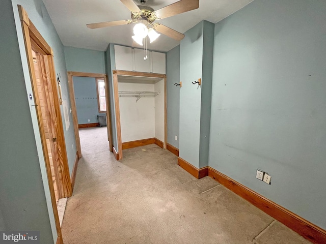 interior space featuring radiator heating unit and light carpet