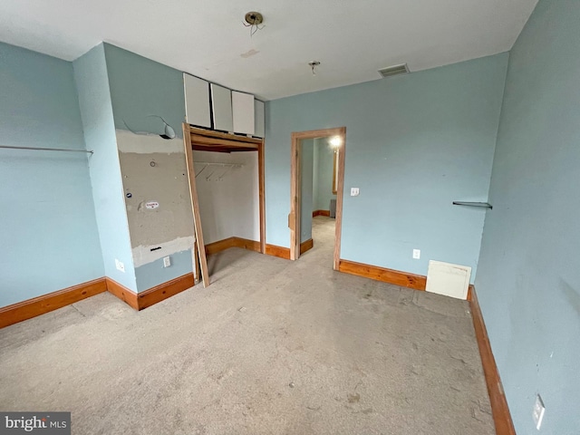 unfurnished bedroom with a closet and light colored carpet