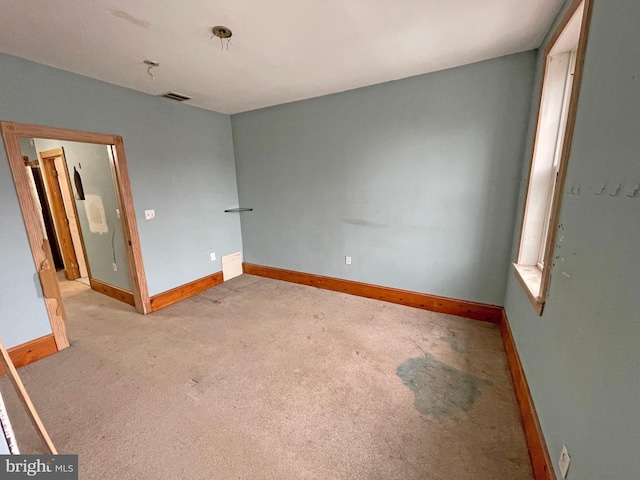 unfurnished bedroom featuring light carpet